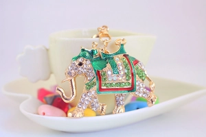 Detail of running elephant keychain with sparkling rhinestones and green enamel accents
