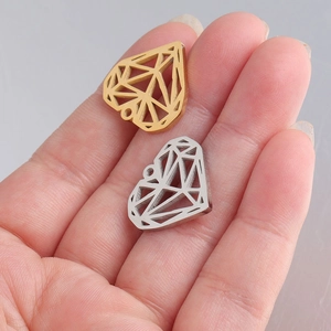 Gold and silver heart pendants in hollow origami diamond style shown in hand