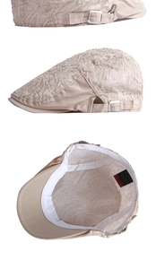 Detalles de boina de encaje beige con hebilla metálica y tela con textura floral