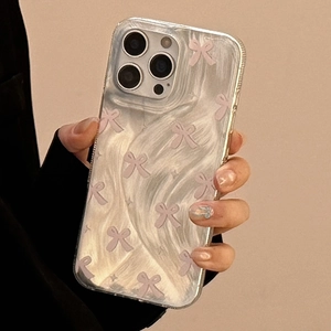 Close-up of clear iPhone case with pink bow and white marble texture for iPhone 16