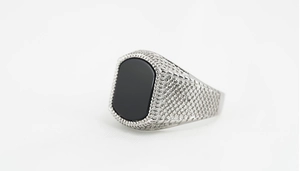 Macro detail of men's titanium steel ring featuring silver mesh texture and black onyx stone