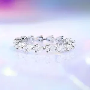 Macro shot of S925 sterling silver band with pear-cut cubic zirconia in a line