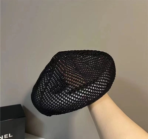 Detail of breathable black mesh beret showing lightweight woven texture for summer