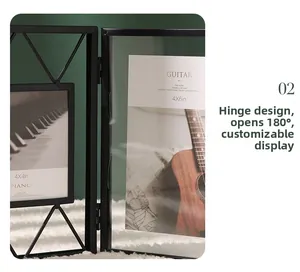 Detail of black metal folding photo frame showing the 180-degree rotating hinge design