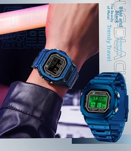 Detail of square digital sports watch featuring blue metal finish and LED backlight