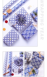 Detail of blue fan pattern wrapping paper with decorative twine and wax seal accents