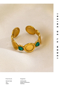 Detail of vintage gold-plated stainless steel ring with green malachite and yellow inlay