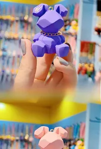 Detailed view of geometric resin bunny keychain with gold chain and star patterns