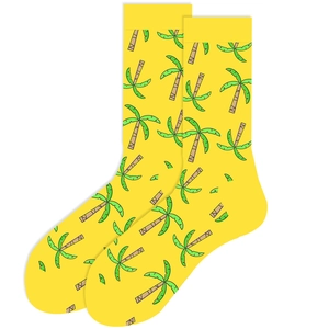 Detailed flat lay of vibrant yellow socks featuring a tropical coconut tree pattern design