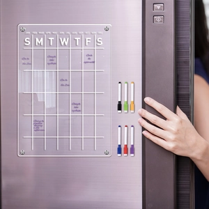 Magnetic acrylic weekly calendar on fridge with six colorful markers and handwritten notes