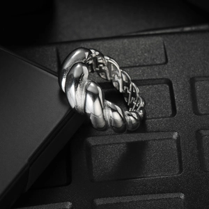 Polished silver twisted croissant ring with internal honeycomb cutout and vintage aesthetic