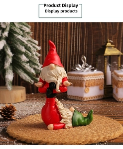 Stacked Christmas faceless gnome figurines with red and green hats on wooden background