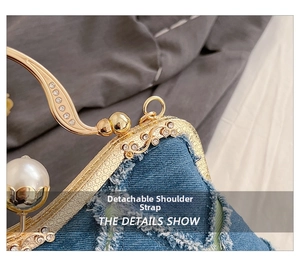 Detailed macro view of denim clutch bag with gold rhinestone frame and pearl detail