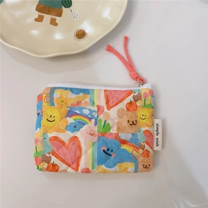 Macro detail of quilted cotton pouch featuring colorful rainbow and cartoon bear prints