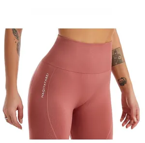Detail of high-waist seamless compression shorts in dusty rose with logo print