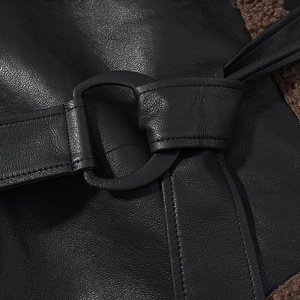 Detailed close-up of leather texture with plush faux shearling lining and metal ring buckle