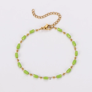 Detail of colorful faceted green beads and gold chain bracelet with adjustable lobster clasp