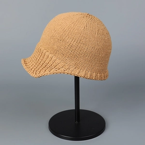Detail of camel knitted breathable baseball cap showing intricate woven texture and curved brim