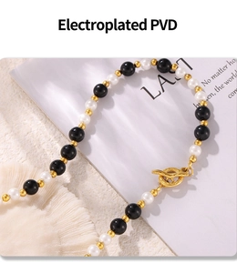 Macro view of PVD plated OT buckle and black onyx beads on the elegant necklace