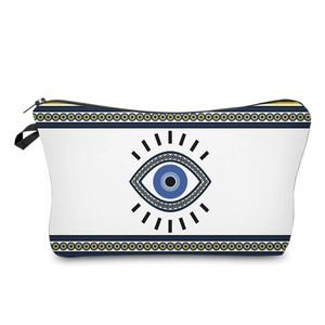 Close-up of durable canvas makeup bag with blue Evil Eye print and black zipper