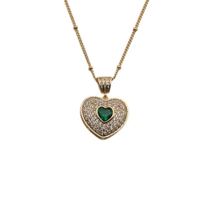Elegant gold heart pendant necklace with green gemstone and beaded chain on white background