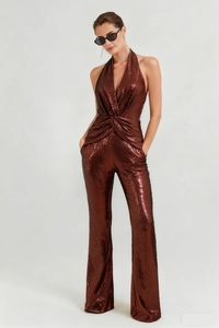 Detail of sequined halter jumpsuit with deep V-neck and twist front in bronze color