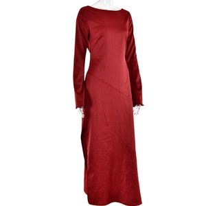 Detail view of red satin long-sleeved evening gown with side slit and waist stitching