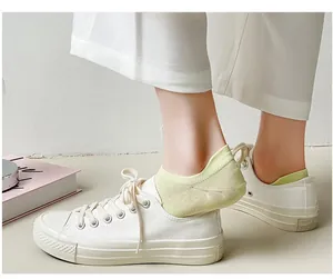 Detail of light green cotton no-show socks with breathable ribbed texture and heel tab
