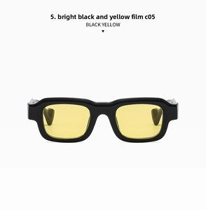 Detail of trendy rectangle sunglasses with bright black frame and yellow lenses