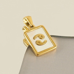 Macro detail of 18k gold plated square pendant featuring a white Cancer zodiac shell inlay