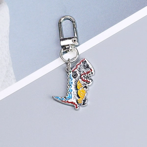 Detail of silver dinosaur alloy keychain with colorful enamel accents on a clean background