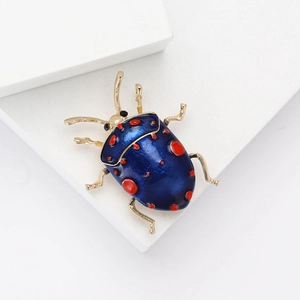 Creative enamel ladybug brooch with blue base and red dots on golden metal alloy legs