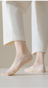 Close-up of elegant floral jacquard lace socks for women in breathable beige cotton fabric