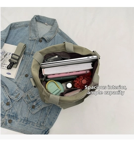 Interior view of large capacity canvas tote bag holding a laptop books and water bottle