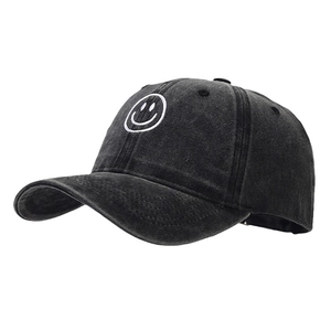 Classic black washed baseball cap with white smiley face embroidery on a clean white background