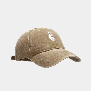 Detailed embroidery of skull hand gesture on vintage khaki washed cotton baseball cap
