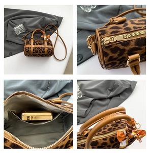 Detail views of leopard print Boston bag showing gold zipper, interior and silk scarf handle