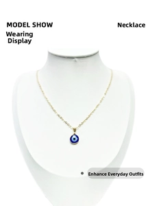 Detail of gold evil eye pendant necklace shown on a model display stand