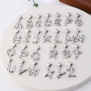 Set of 26 silver alphabet heart pendants with colorful zircon inlays on display