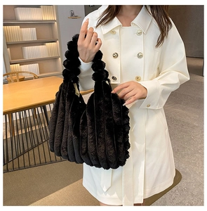 Close-up of black plush tote bag featuring soft faux fur with vertical striped textures
