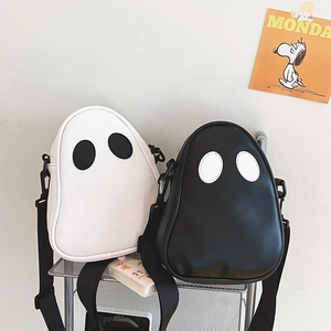 Close-up of cartoon ghost crossbody bags in black and white with contrast eye details