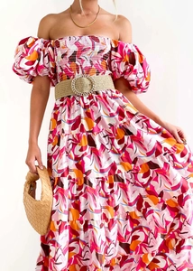 Detail of puff sleeves and abstract floral print on a summer vacation dress with woven belt