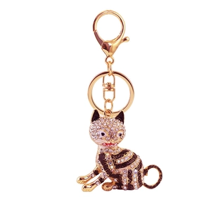 Golden sitting cat keychain with sparkling rhinestones and black enamel stripes