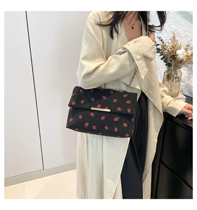Détail du sac bandoulière en velours côtelé à imprimé fraise avec boucle en métal