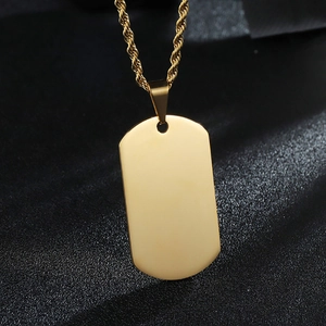 Detailed close-up of a polished gold stainless steel rectangle pendant on a twist chain