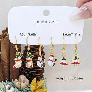 Detailed view of Christmas enamel earrings set with dimensions on a festive background