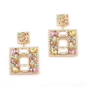 Detailed shot of large geometric earrings featuring multi-color crystals in gold setting