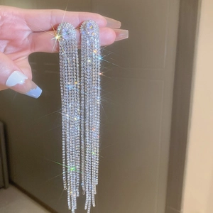 Sparkling silver needle leaf tassel earrings with rhinestones shown on a model