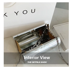 Detail view of the silver mirror evening clutch bag showing its interior and metal chain