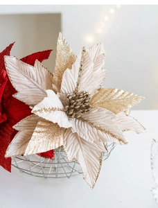 Close-up of velvet poinsettia Christmas flower with gold glitter and sequins